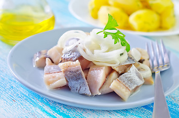 Image showing herring with onion on blue plate