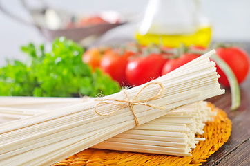 Image showing raw pasta and  tomato and sauce