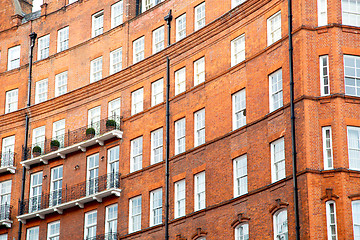 Image showing window in  red brick wall and      historical 