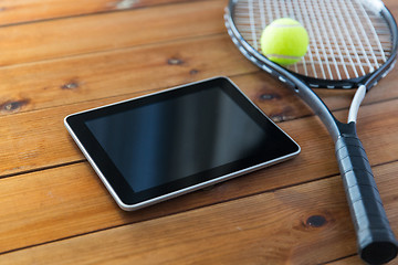Image showing close up of tennis racket with ball and tablet pc