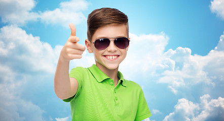 Image showing smiling boy in sunglasses and green polo t-shirt