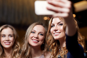 Image showing women with smartphone taking selfie at night club