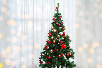 Image showing christmas tree in living room over window curtain