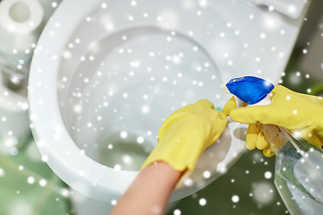 Image showing close up of hand with detergent cleaning toilet