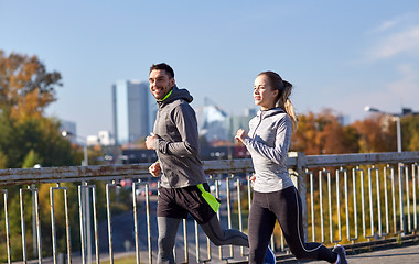 Image showing happy couple running outdoors