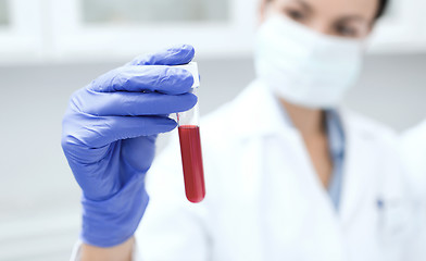 Image showing close up of scientist holding test tube in lab