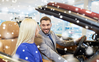 Image showing happy couple buying car in auto show or salon