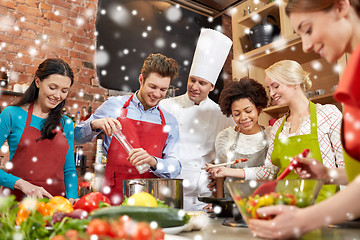 Image showing happy friends and chef cook cooking in kitchen