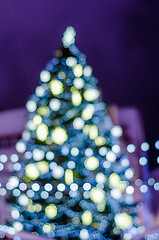 Image showing Decorated Christmas tree. Blurred lights background