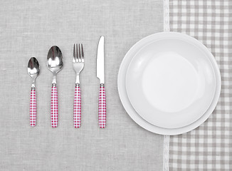 Image showing empty plate with fork, spoon and knife