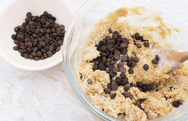 Image showing Adding chocolate chips to cookie dough