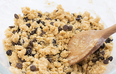 Image showing Stirring chocolate chips into cookie dough