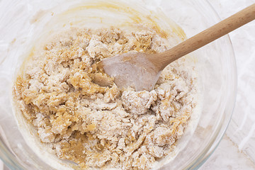 Image showing Stirring dough to make peanut butter cookies