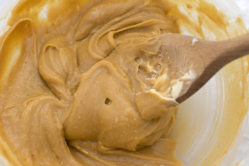 Image showing Peanut butter and butter with a wooden spoon