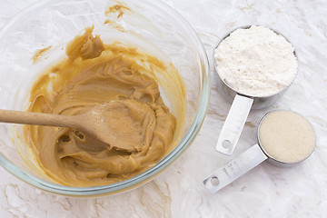 Image showing Cups of flour and sugar with peanut butter mixture