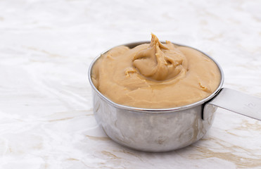 Image showing Peanut butter in a measuring cup