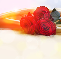 Image showing red roses on silk background