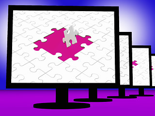 Image showing Unfinished Puzzle On Monitors Showing Completion