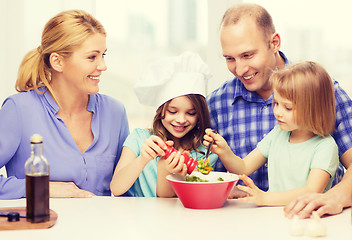 Image showing happy family with two kids making dinner at home