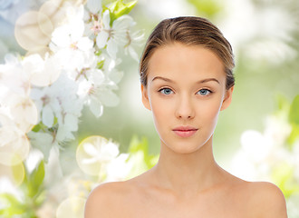 Image showing young woman face over cherry blossoms