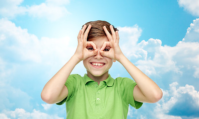 Image showing happy boy in t-shirt having fun and making faces