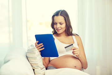 Image showing pregnant woman with tablet pc and credit card