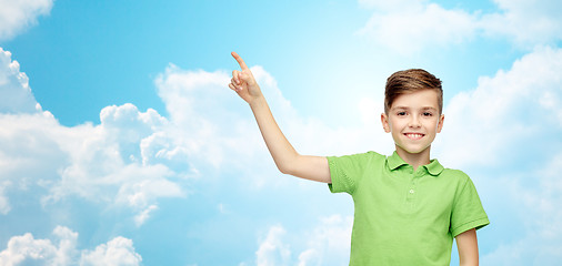 Image showing happy boy in green polo t-shirt pointing finger up