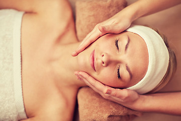 Image showing close up of young woman having face massage in spa