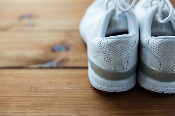 Image showing close up of sneakers on wooden floor