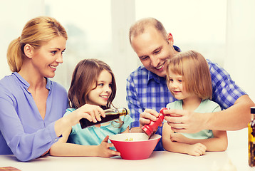 Image showing happy family with two kids making dinner at home