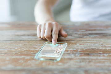 Image showing close up of woman with transparent smartphone