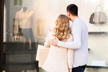 Image showing couple with shopping bags looking at shop window