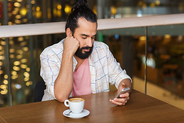 Image showing man with smartphone and coffee at restaurant