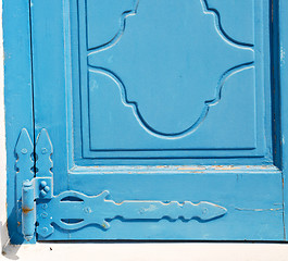 Image showing in the old wall a hinged window blue wood and rusty metal