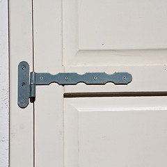 Image showing in the old wall a hinged window blue wood and rusty metal