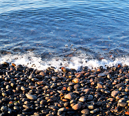 Image showing stone in the coastline sunrise and light ocean white sky