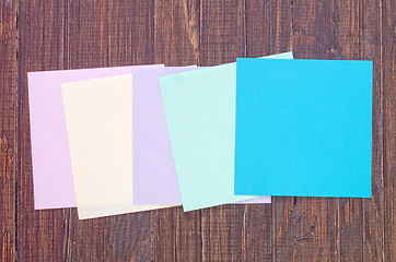 Image showing color paper on wooden background