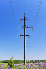 Image showing High-voltage electric pole with wires on a background of blue sk