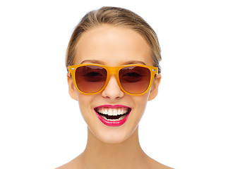 Image showing happy young woman in sunglasses with pink lipstick