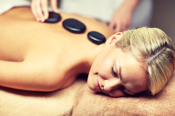 Image showing close up of woman having hot stone massage in spa