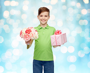 Image showing happy boy holding flower bunch and gift box