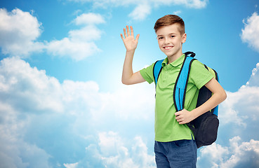 Image showing happy student boy with school bag waving hand