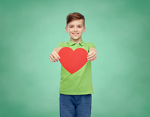 Image showing happy school boy holding red heart shape