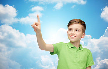 Image showing happy boy in green polo t-shirt pointing finger up