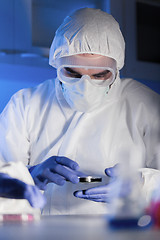 Image showing close up of male scientist with test sample in lab