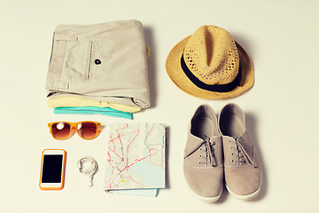 Image showing close up of summer clothes and travel map on table