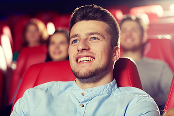 Image showing happy young man watching movie in theater