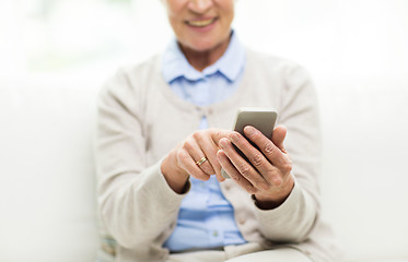 Image showing close up of senior woman with smartphone texting