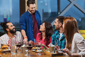 Image showing friends dining and drinking wine at restaurant