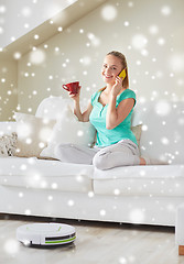 Image showing happy woman with smartphone drinking tea at home